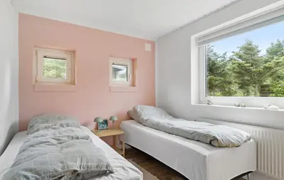 a bedroom with two beds and a window at 4 Bedroom Beach Front Home In Thyholm in Thyholm