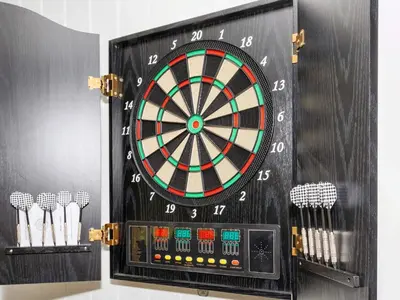 a dart board with darts on a wall at 4 star holiday home in Gedsted-By Traum in Gedsted