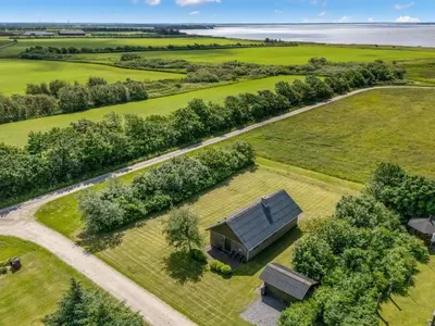 an overhead view of a house in a field with trees at Holiday Home Arlin - 380m to the fjord by Interhome in Vemb