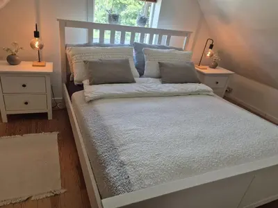 a bed in a room with two night stands at Holiday Home Cillvur - 8km from the sea by Interhome in Thisted