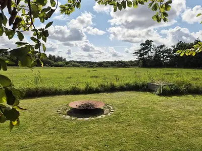 a grassy field with a fountain in the middle of a field at Holiday Home Cillvur - 8km from the sea by Interhome in Thisted