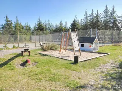 a playground with a ladder and a play structure at Holiday Home Pihla - 1-1km from the sea by Interhome in Fjerritslev
