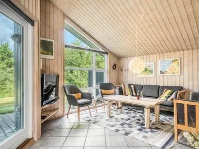 a living room with a couch and a table at Holiday Home Ane - 800m from the sea by Interhome in Fjerritslev