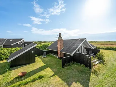 an external view of a house with a black fence at Holiday Home Angelie - 400m from the sea by Interhome in Harboør