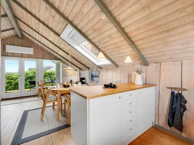 a kitchen and dining room of a tiny house at Holiday Home Angelie - 400m from the sea by Interhome in Harboør