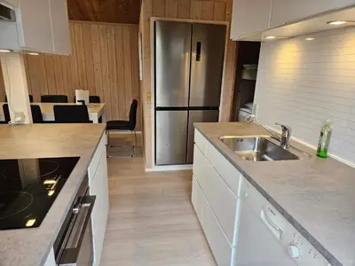 a kitchen with a sink and a stainless steel refrigerator at 7 person holiday home in Vestervig-By Traum in Vestervig