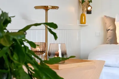 a table with two wine glasses and a plant at Rold Gl Kro in Arden