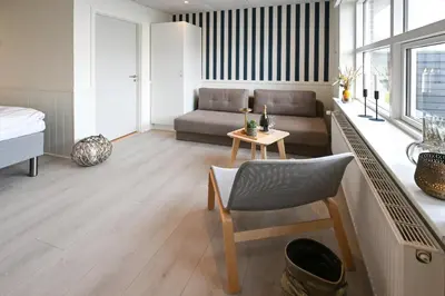 a living room with a couch and a table at Rold Gl Kro in Arden