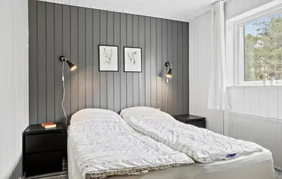 a bedroom with a bed and two lamps and a window at 4 Bedroom Lovely Home In Vestervig in Vestervig