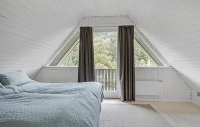 a bedroom with a bed and a large window at 3 Bedroom Stunning Home In Højslev in Højslev