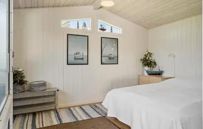 a bedroom with a white bed and two windows at 3 Bedroom Beautiful Home In Vinderup in Vinderup