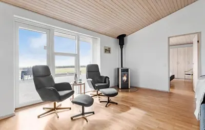a living room with three chairs and a fireplace at Amazing Home In Vesløs With Wifi in Øsløs