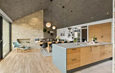 an open kitchen and dining room with a dining table at 4 Bedroom Pet Friendly Home In Blokhus in Blokhus