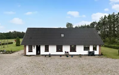 a white house with a black roof at 5 Bedroom Beautiful Home In Brovst in Brovst