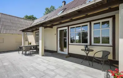 a patio with chairs and a table in front of a house at Stunning Home In Ranum With Wifi in Ranum