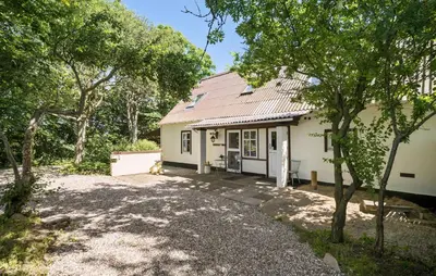 a small white house with a metal roof at Stunning Home In Ranum With Wifi in Ranum