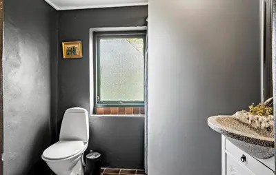 a bathroom with a toilet and a sink and a window at Nice Home In Harboøre With Wifi in Harboør