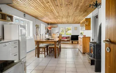 a kitchen with a table and a dining room at Nice Home In Harboøre With Wifi in Harboør