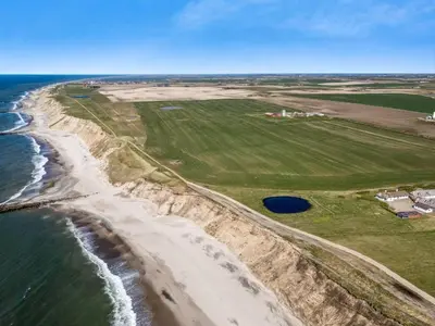 an aerial view of a beach and the ocean at Holiday Home Vili - 100m from the sea by Interhome in Lemvig