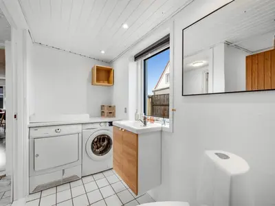 a bathroom with a washing machine and a sink at Holiday Home Darja - 300m from the sea by Interhome in Thyborøn