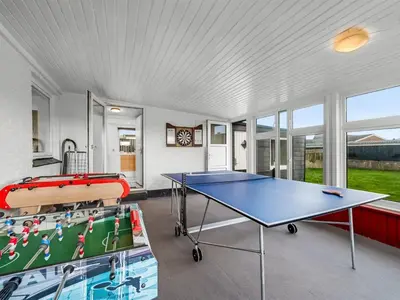 a room with a ping pong table in it at Holiday Home Darja - 300m from the sea by Interhome in Thyborøn