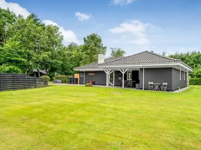 a gray house with a large yard at Holiday Home Lyra - 500m to the fjord by Interhome in Øsløs