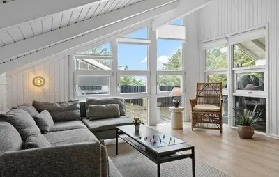 a living room with a couch and a table at Awesome Home In Løkken With Kitchen in Løkken