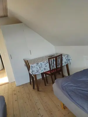 a room with a table and two chairs and a bed at Rødkælkevej's B&B in Hurup