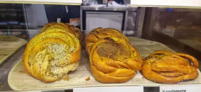 three loaves of bread sitting on a cutting board at Motel Gavlhuset in Nørager