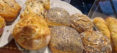 a bunch of different types of pastries in a display case at Motel Gavlhuset in Nørager