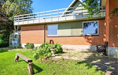 a house with a bench in front of it at 2 Bedroom Stunning Home In Erslev in Erslev