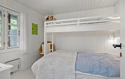 a bedroom with white walls and a bunk bed at Beautiful Home In Blokhus in Blokhus