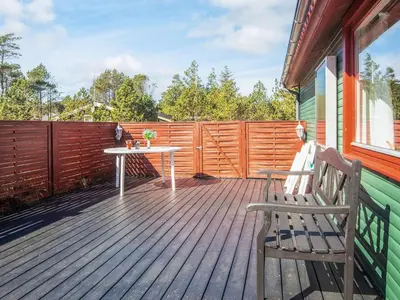 a wooden deck with a table and a bench at 4 person holiday home in Thisted-By Traum in Thisted