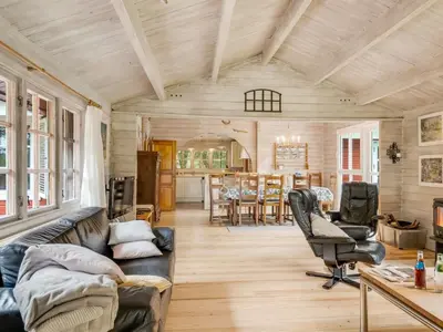 a living room with a couch and a table at Holiday Home Aisling - 700m from the sea by Interhome in Brovst