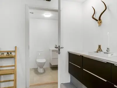 a bathroom with a toilet and a sink at Apartment Thorgot - 3km from the sea by Interhome in Pandrup