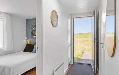 a bedroom with a bed and a view of the ocean at Gorgeous Home In Pandrup With Wifi in Pandrup