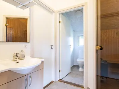 a bathroom with a sink and a toilet at 14 person holiday home in Højslev in Sundstrup