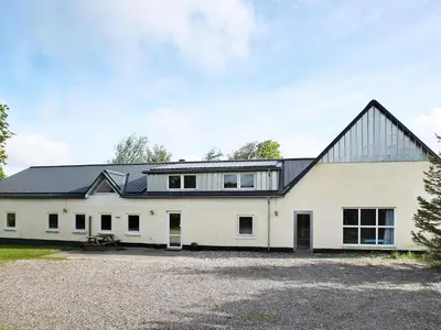 a white barn with a black roof at 14 person holiday home in Løgstør-By Traum in Løgstør
