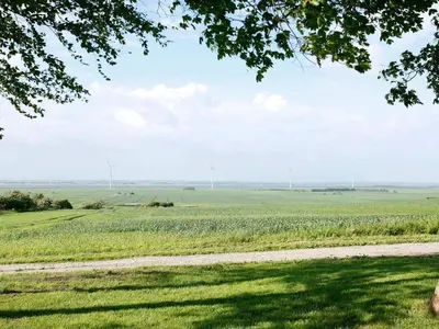 a field of green grass with a dirt road at 14 person holiday home in Løgstør-By Traum in Løgstør