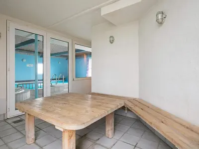 a wooden bench sitting in the corner of a room at 14 person holiday home in Løgstør-By Traum in Løgstør