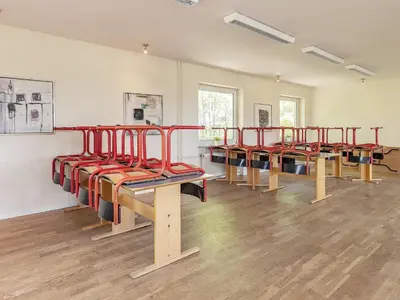 a row of benches in an empty room at Rustic Retreat in Gettrup - By Traum Ferienwohnungen in Sindrup