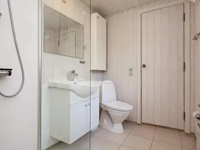 a white bathroom with a toilet and a sink at 8 person holiday home in Hurup Thy-By Traum in Sindrup