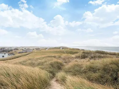 a view of the ocean from a beach with tall grass at Seaside Escape with Swing in Vrist