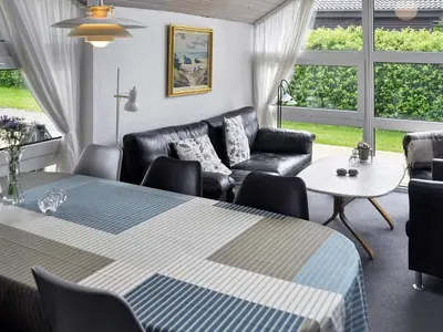 a living room with a table and a couch at 6 person holiday home in Struer-By Traum in Remmer Strand