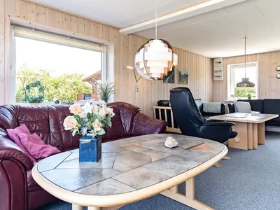 a living room with a table and leather furniture at 10 person holiday home in Vinderup-By Traum in Vinderup