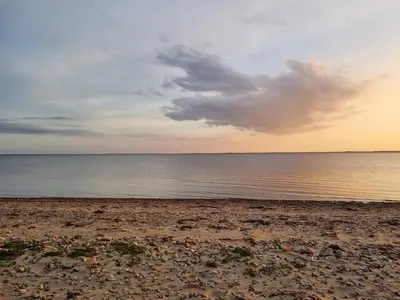 a beach with a cloudy sky and the ocean at 6 person holiday home in Spøttrup-By Traum in Lihme