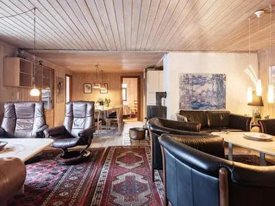 a living room with leather chairs and a table at 12 person holiday home in Pandrup-By Traum in Rødhus