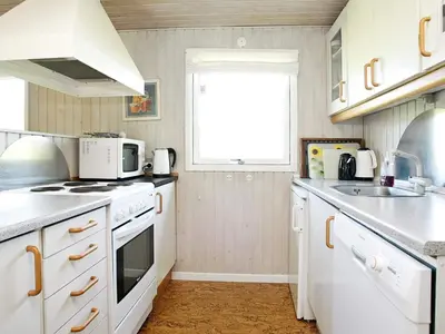 a kitchen with white appliances and a window at 6 person holiday home in Pandrup-By Traum in Rødhus