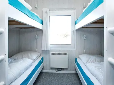 two bunk beds in a room with a window at Luxury Pool Villa Retreat - By Traum Ferienwohnungen in Blokhus