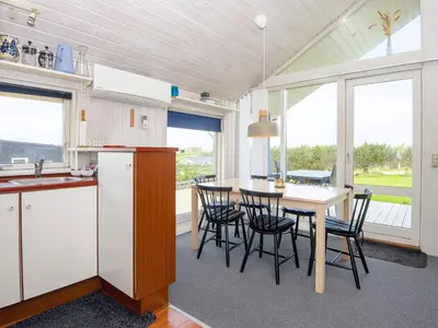 a kitchen and dining room with a table and chairs at 4 person holiday home in Lemvig-By Traum in Lemvig